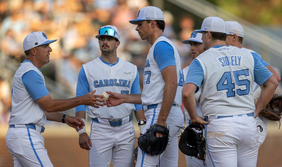 North Carolina pitcher Aidan Haugh (47) hands the ball to coach Scott Forbes after giving up three runs on seven hits in the top of the fifth inning against N. C. State on Friday, May 9, 2025 at Boshamer Stadium in Chapel Hill, N.C.