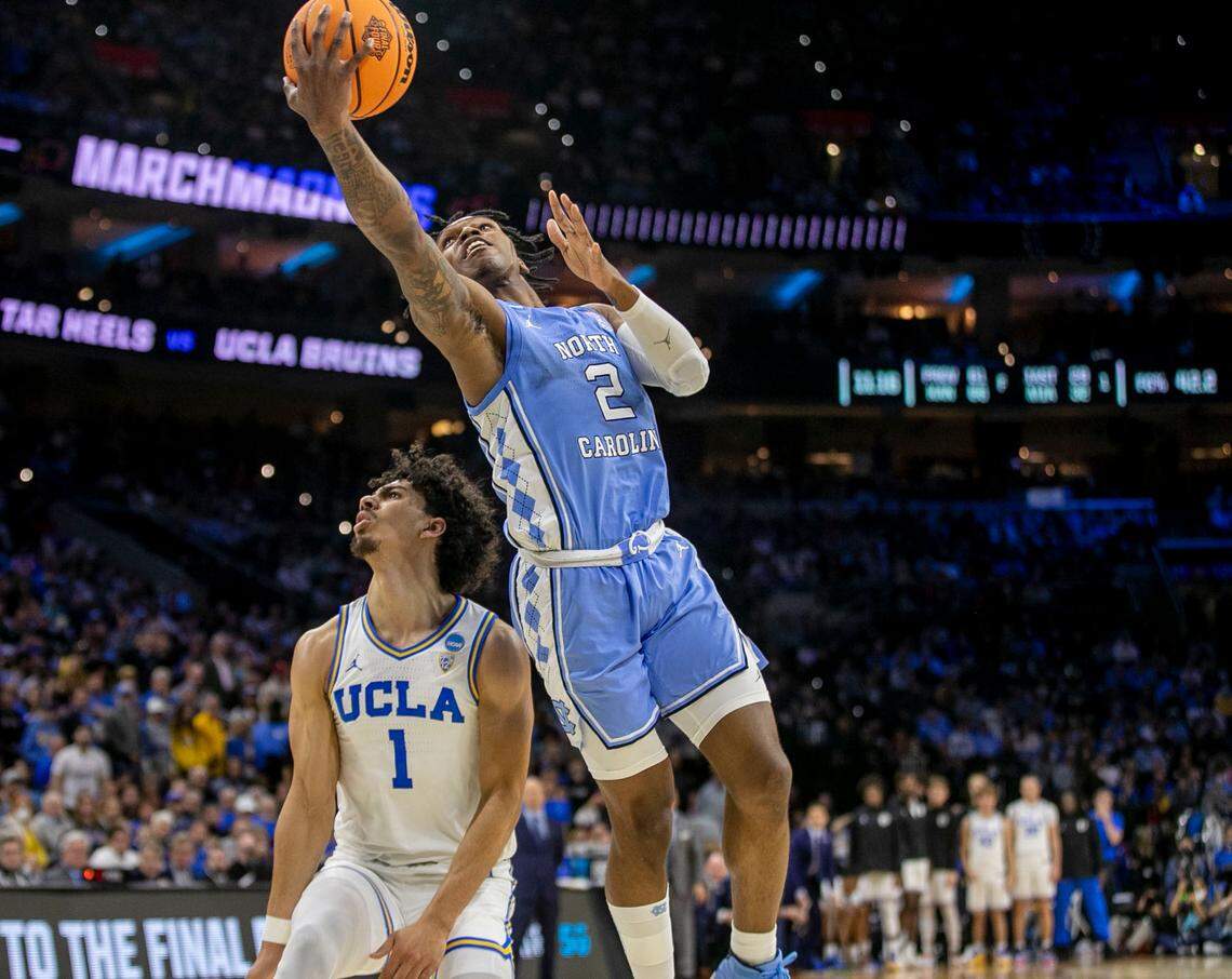 North Carolina’s Caleb Love (2) breaks to the basket against UCLA ’s Jules Bernard (1) for two of his game high 30 points during the second half on Friday, March 25, 2022 during the NCAA East Regional semi-final at Wells Fargo Center in Philadelphia, Pa.