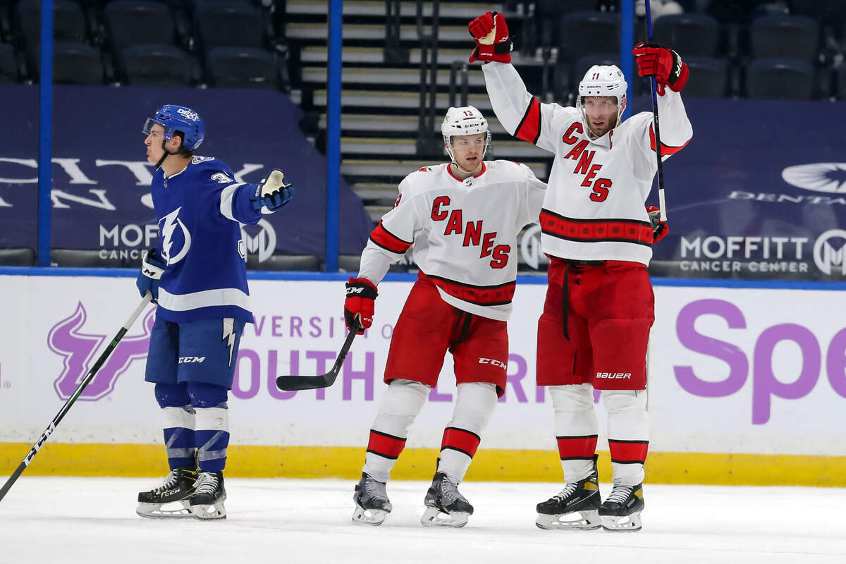 Carolina Hurricanes’ Jordan Staal, right, celebrates his goal with Warren Foegele as Tampa Bay Lightning’s Yanni Gourde reacts during the second period of an NHL hockey game Tuesday, April 20, 2021, in Tampa, Fla. (AP Photo/Mike Carlson)