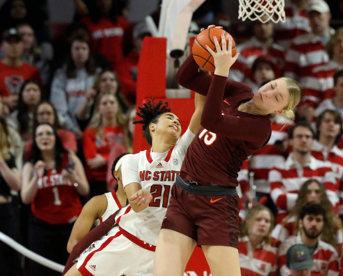 Virginia Tech’s Clara Strack pulls down a rebound away from N.C. State’s Madison Hayes during the second half of the Wolfpack’s 72-61 loss on Thursday, Feb. 8, 2024, at Reynolds Coliseum in Raleigh, N.C.