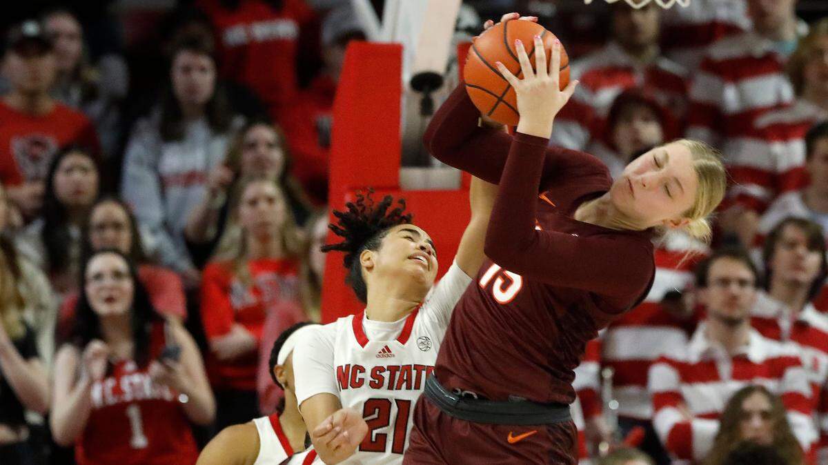 Virginia Tech’s Clara Strack pulls down a rebound away from N.C. State’s Madison Hayes during the second half of the Wolfpack’s 72-61 loss on Thursday, Feb. 8, 2024, at Reynolds Coliseum in Raleigh, N.C.