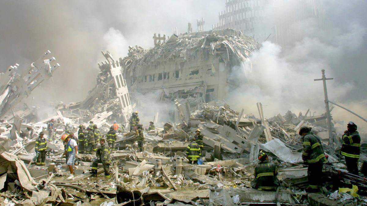 Firefighters make their way through the rubble after terrorists crashed two airliners into the World Trade Center in a deadly series of blows Tuesday that brought down the twin 110-story towers in New York Tuesday, Sept. 11, 2001.
