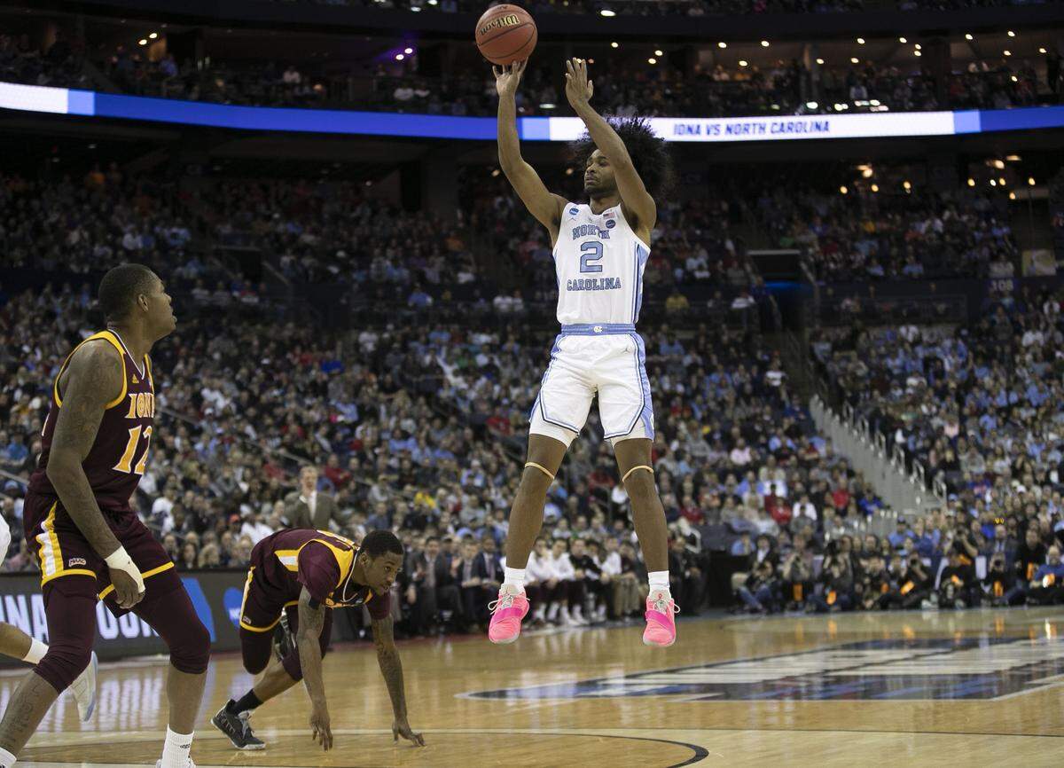 North Carolina’s Coby White (2) launches a shot over Iona’s Rickey McGill (0) and Tajuan Agee (12) during the second half on Friday, March 22, 2019 at Nationwide Arena in Columbus, Ohio.