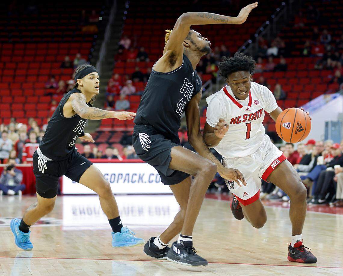 North Carolina State Wolfpack guard Jarkel Joiner drives past Florida International Golden Panthers guard Javaunte Hawkins and center Seth Pinkney during the first half of a men’s basketball game at PNC Arena on Tuesday, Nov. 15, 2022, in Raleigh, N.C.