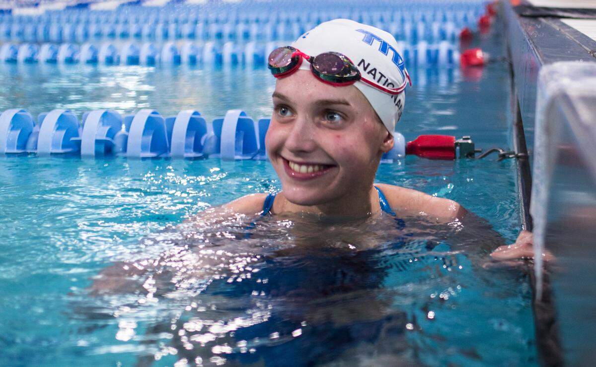 Olympic qualifier Claire Curzan, 17, smiles at her coach while practicing for the 2020 Tokyo Olympics at the Triangle Aquatic Center in Cary, N.C. on June 24, 2021. Curzan is a Cary native and will be one of the youngest competitors at the games in Tokyo.