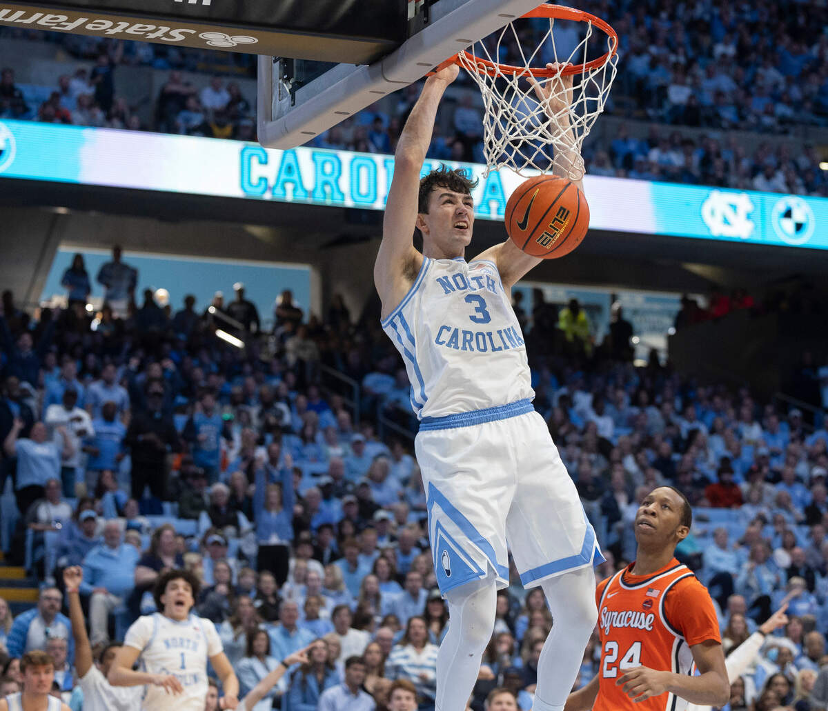 North Carolina’s Cormac Ryan (3) gets a dunk in the second half over Syracuse’s Quadir Copeland (24) on Saturday, January 13, 204 at the Smith Center in Chapel Hill, N.C.