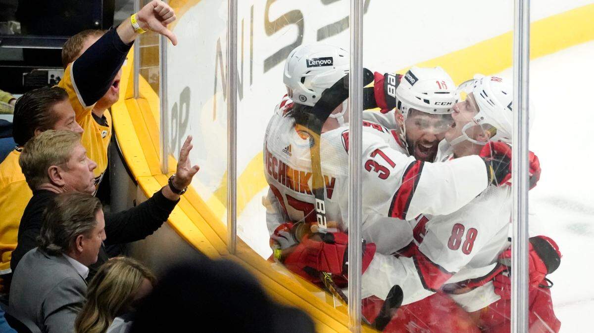 Carolina Hurricanes right wing Andrei Svechnikov (37) celebrates with Vincent Trocheck (16) and Martin Necas (88) after Svechnikov scored a goal against the Nashville Predators in the third period of an NHL hockey game Saturday, Oct. 16, 2021, in Nashville, Tenn. The Hurricanes won 3-2. (AP Photo/Mark Humphrey)