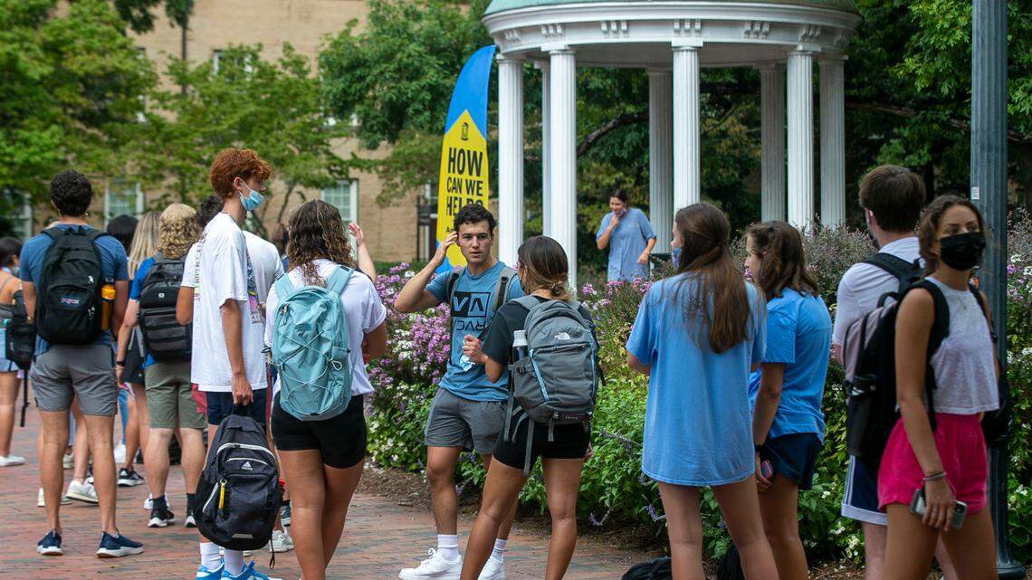 University of North Carolina students wait in line to take their ceremonious first drink from The Old Well on the first day of classes on Wednesday, August 18, 2021 in Chapel Hill, N.C.