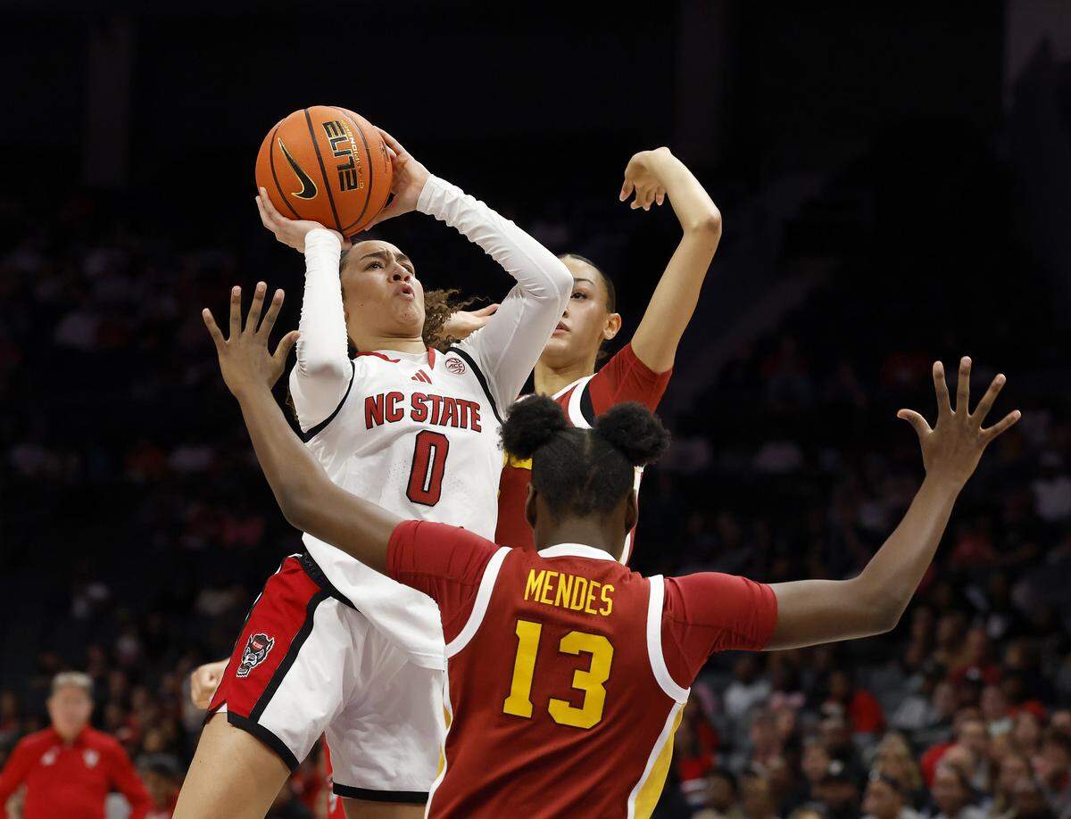 N.C. State’s Devyn Quigley drives against Southern California’s Dayana Mendes during the first half of the Wolfpack’s game on Sunday, Nov. 9, 2025, at Spectrum Center in Charlotte, North Carolina.