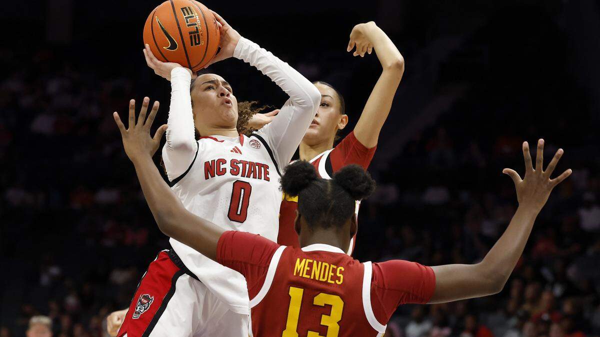 N.C. State’s Devyn Quigley drives against Southern California’s Dayana Mendes during the first half of the Wolfpack’s game on Sunday, Nov. 9, 2025, at Spectrum Center in Charlotte, N.C.