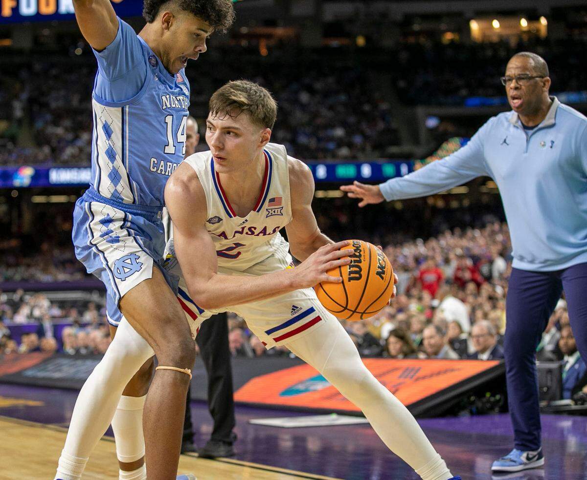 North Carolina’s Puff Johnson (14) traps Kansas’ Christian Braun (2) in the second half during the NCAA Championship game on Monday, April 4, 2022 at Caesars Superdome in New Orleans, La.