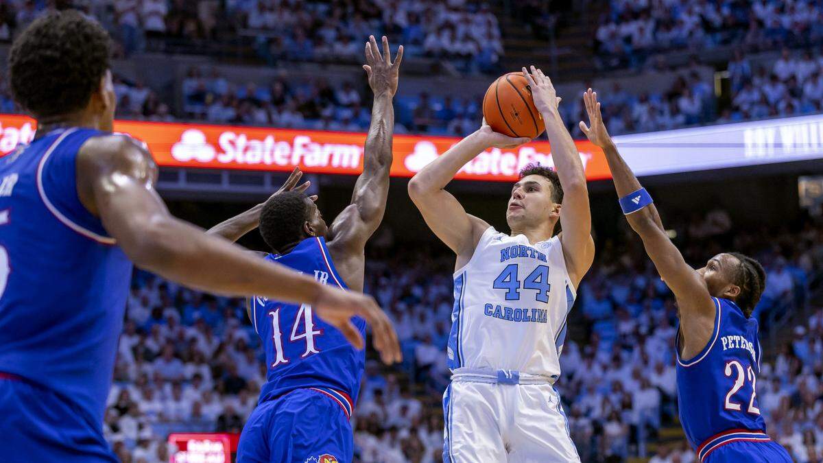 Kansas guard Melvin Council Jr. (14) and guard Darryn Peterson (22) defend North Carolina guard Luka Bogavac (44) in the first half on Friday, November 7, 2025 at the Smith Center in Chapel Hill, N.C.