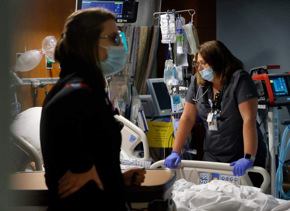 Nurse practitioner Bethany Pierson and respiratory clinical specialist Alicia Taylor work with a patient in the Cardiovascular & Thoracic Intensive Care Unit at UNC Hospital on Thursday, Sept. 29, 2022, in Chapel Hill, N.C.