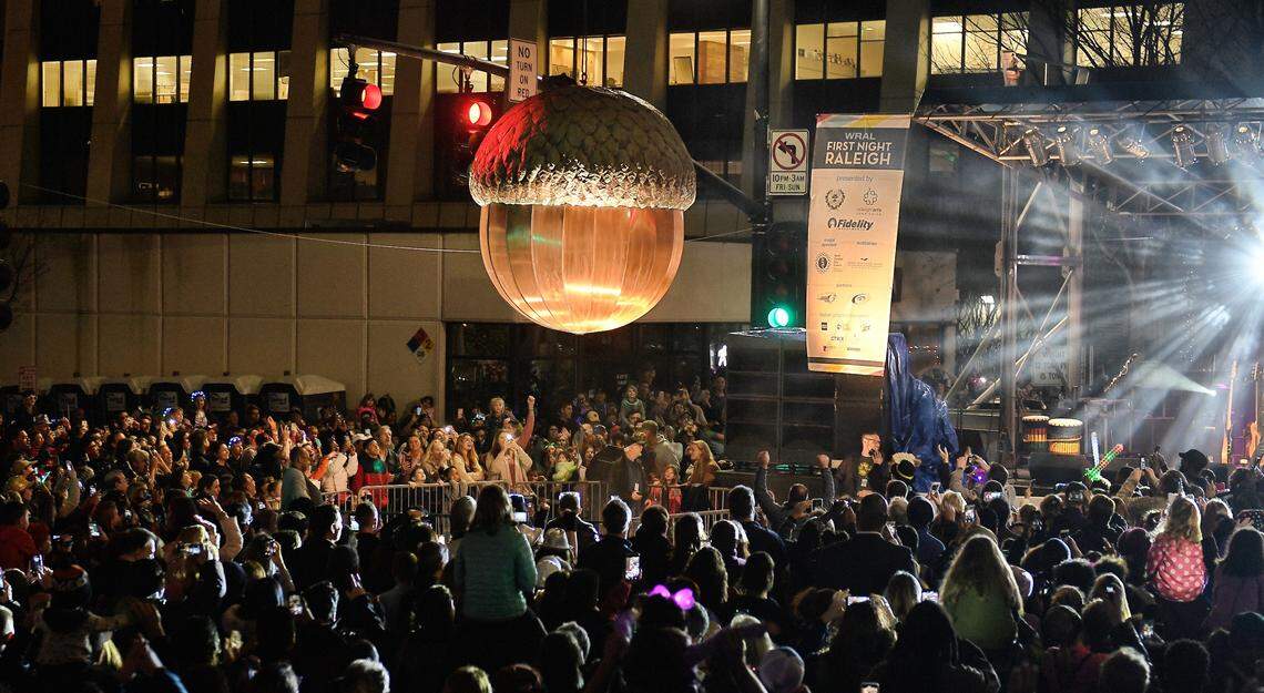 The crowd celebrates at the 2018 First night Raleigh as the city’s giant acorn is lowered for the early “acorn drop” on Fayetteville Street. The celebration in the City of Oaks features two drops of the copper acorn, one at 7 p.m. on New Year’s Eve, and the other at midnight.