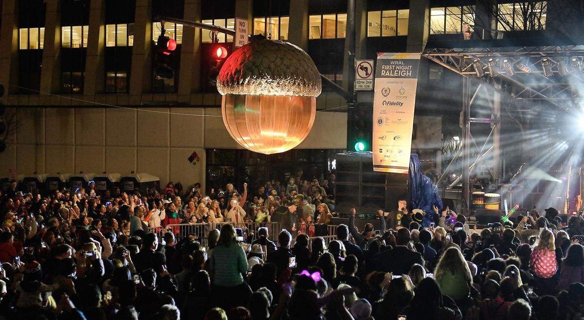 The crowd celebrates at the 2018 First night Raleigh as the city’s giant acorn is lowered for the early “acorn drop” on Fayetteville Street. The celebration in the City of Oaks features two drops of the copper acorn, one at 7 p.m. on New Year’s Eve, and the other at midnight.