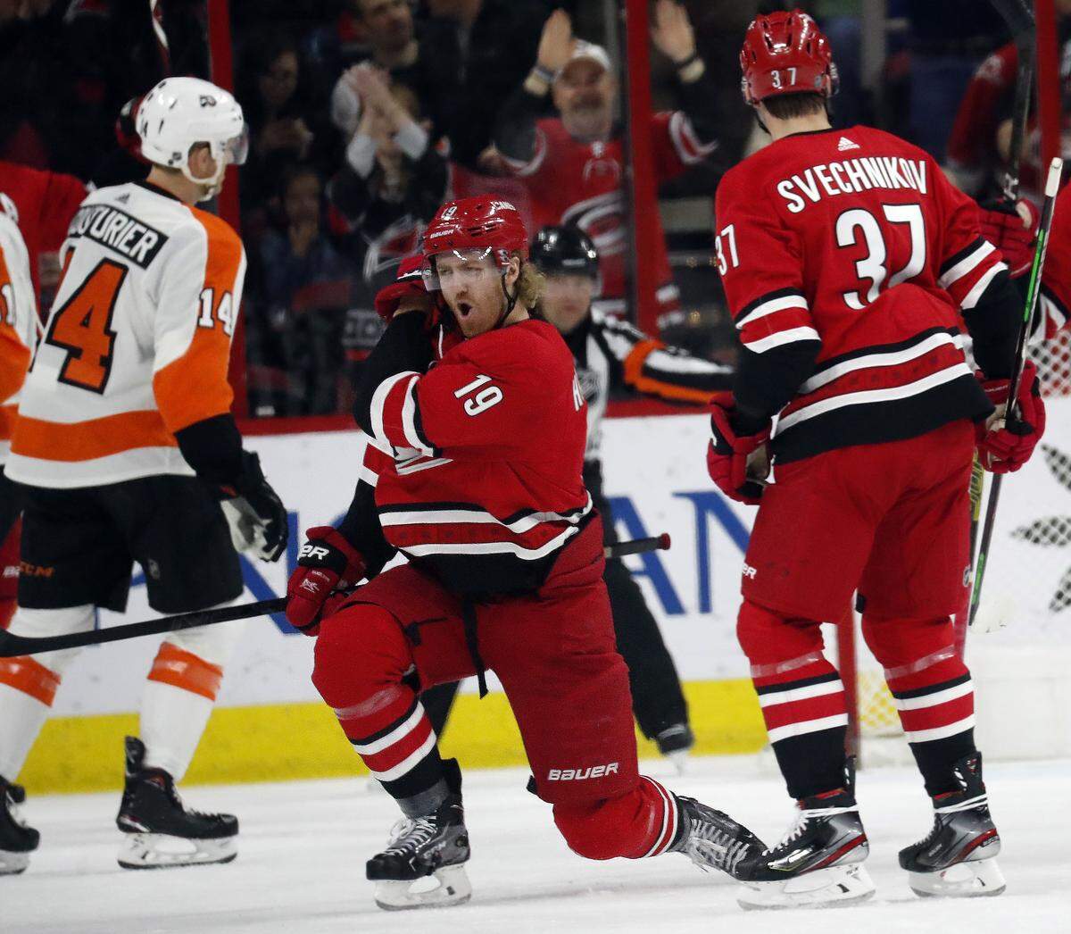 Carolina Hurricanes’ Dougie Hamilton (19) celebrates his goal with Andrei Svechnikov (37) of Russia while Philadelphia Flyers’ Sean Couturier (14) skates away during the first period of an NHL hockey game in Raleigh, N.C., Saturday, March 30, 2019. (AP Photo/Chris Seward)