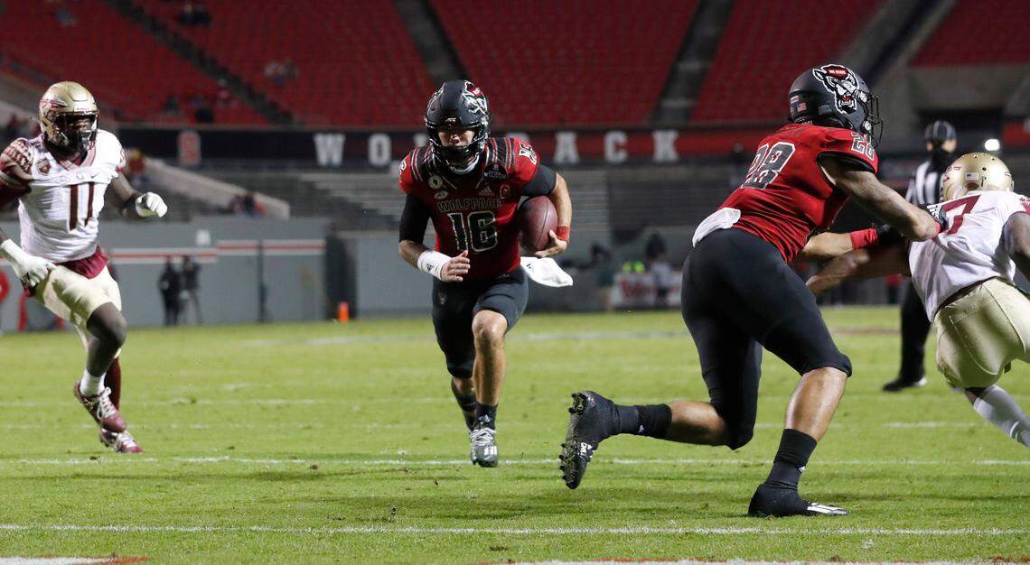 N.C. State quarterback Bailey Hockman (16) scores a touchdown on a 4-yard run during the first half of N.C. State’s game against Florida State at Carter-Finley Stadium in Raleigh, N.C., Saturday, Nov. 14, 2020.