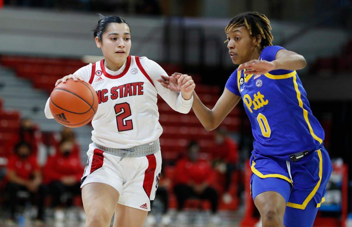 N.C. State’s Raina Perez (2) brings the ball past Pittsburgh’s Sandrine Clesca (0) during the first half of N.C. State’s game against Pittsburgh at Reynolds Coliseum in Raleigh, N.C., Thursday, February 25, 2021.