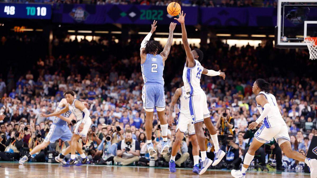 North Carolina’s Caleb Love (2) hits a three-pointer with 25 seconds left in the game to give the Tar Heels a 78-74 lead during the second half of UNC’s 81-77 victory over Duke in the Final Four at Caesars Superdome in New Orleans, La., Saturday, April 2, 2022. Duke’s Mark Williams (15) defends.