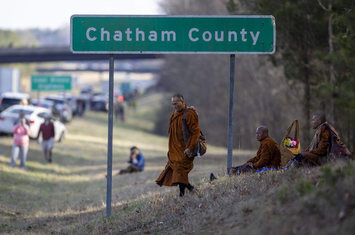 Buddhist Monks take a break at the Chatham County line along US 421, as the Walk for Peace passes through central North Carolina on Wednesday, January 21, 2026.