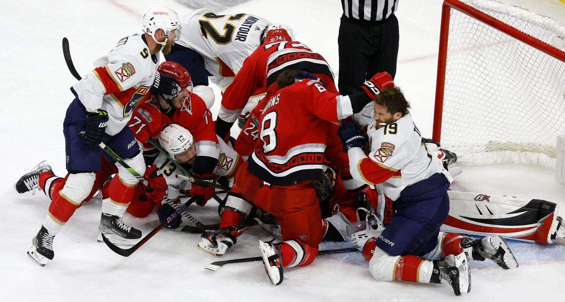 Players pile in front of the net after Carolina goaltender Antti Raanta (32) dove on the puck during the second period of game two between the Hurricanes and Panthers in the Eastern Conference Finals at PNC Arena in Raleigh, N.C., Saturday, May 20, 2023.
