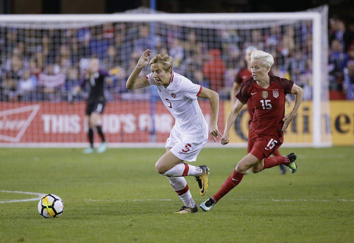 Canada defender Rebecca Quinn (5) and United States forward Megan Rapinoe (15) chase after the ball during the first half of an international friendly women’s soccer match, Sunday, Nov. 12, 2017, in San Jose, Calif. (AP Photo/Eric Risberg)