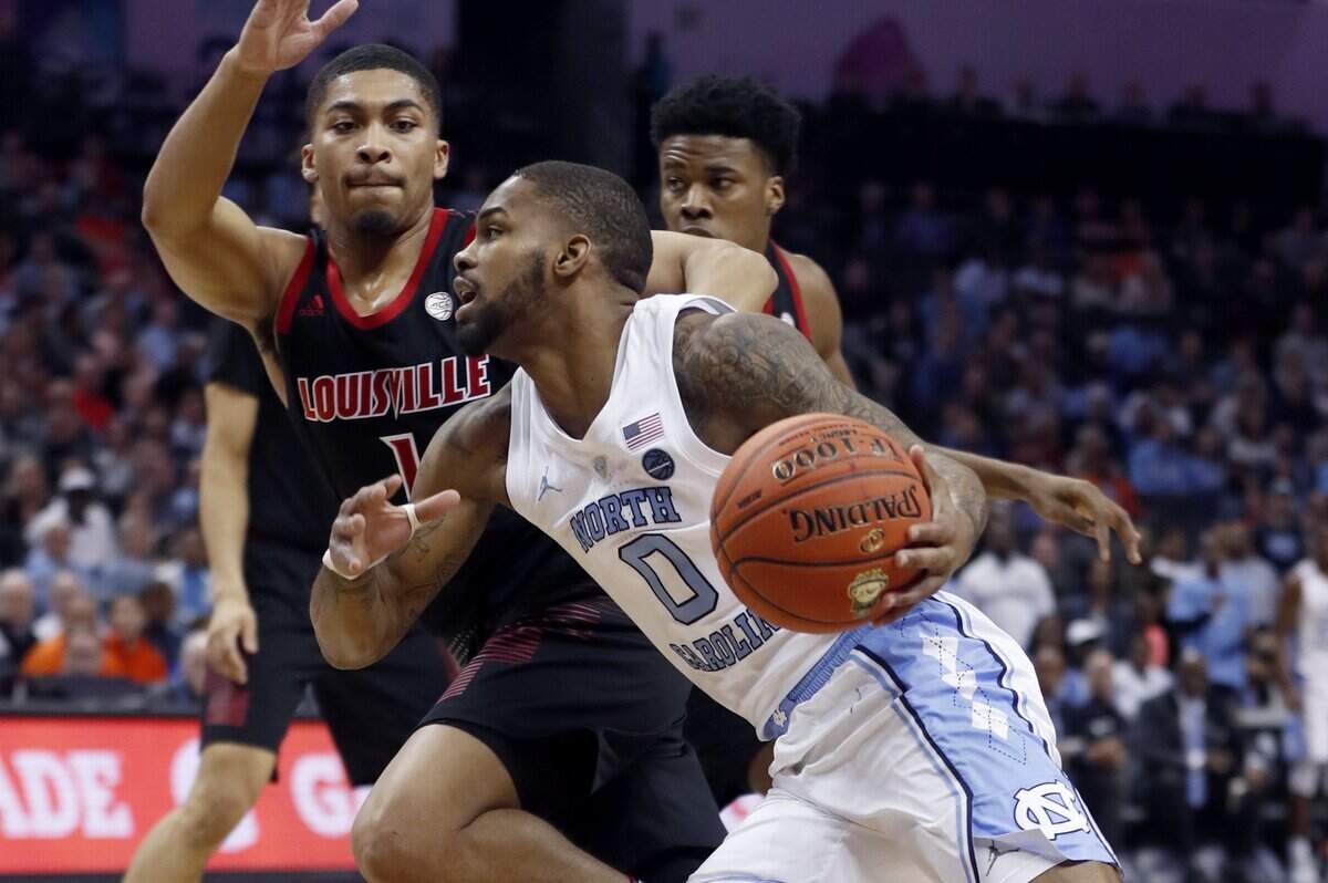 North Carolina’s Seventh Woods (0) drives past Louisville’s Christen Cunningham (1) during the first half of UNC’s game against Louisville in the quarterfinals of the 2019 ACC Tournament in Charlotte, N.C., Thursday, March 14, 2019.