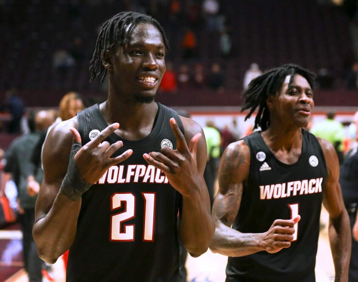 North Carolina State’s Ebenezer Dowuona (21) and Dereon Seabron (1) celebrate the team’s win over Virginia Tech in an NCAA college basketball game Tuesday, Jan. 4, 2022, in Blacksburg, Va. (Matt Gentry/The Roanoke Times via AP)