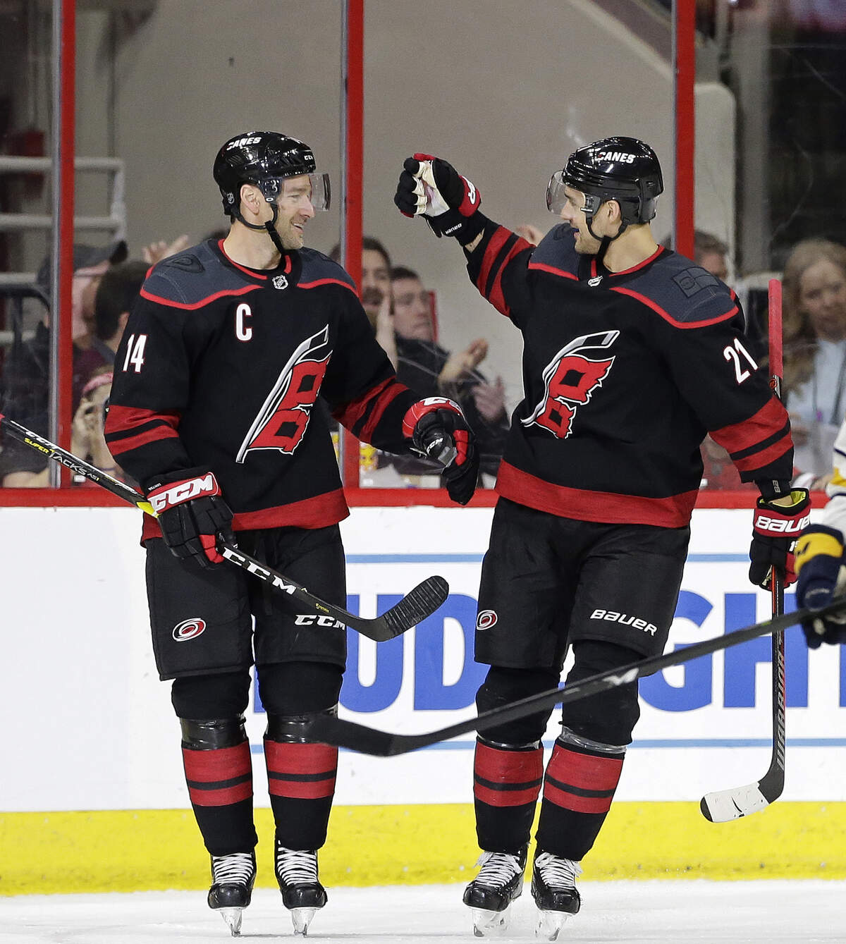 Carolina Hurricanes’ Justin Williams (14) is congratulated by Nino Niederreiter (21), of the Czech Republic, following Williams’ goal against the Buffalo Sabres during the second period of an NHL hockey game in Raleigh, N.C., Saturday, March 16, 2019. (AP Photo/Gerry Broome)