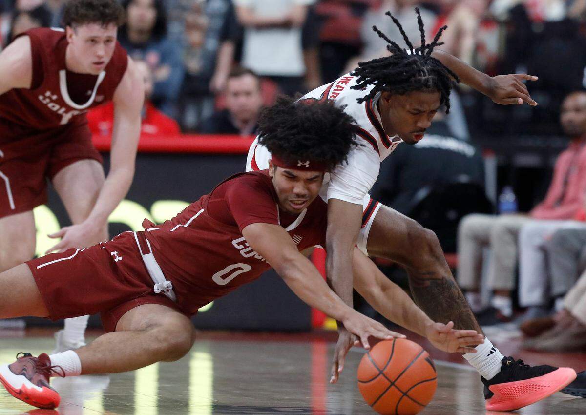 Colgate’s Julian Scott and N.C. State’s Bryce Heard lunge for a loose ball during the first half of the Wolfpack’s game at Lenovo Center on Monday, Nov. 18, 2024, in Raleigh, N.C.