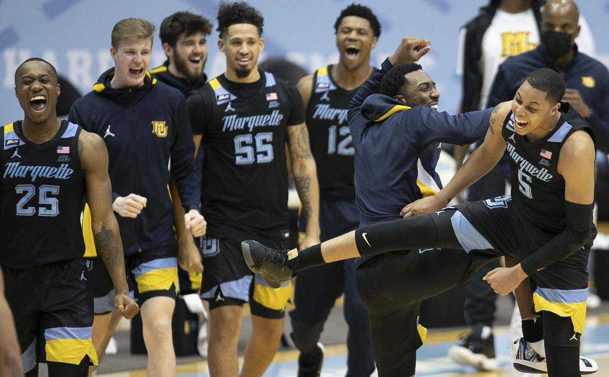 Marquette’s Samir Torrence (10) and Greg Elliott (5) celebrate their 83-70 victory over North Carolina on Wednesday, February 24, 2021 at the Smith Center in Chapel Hill, N.C.