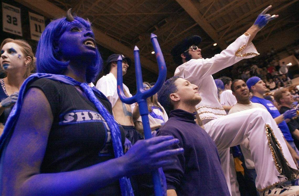 Kiki Jenkins, left, a graduate student at Duke, is amongst the crowd as Elvis, actually Duke MBA graduate student Chris Rae, plays his character as he taunts the UNC players during pregame warm ups at Cameron Indoor Stadium on Thursday, Feb. 1, 2001.