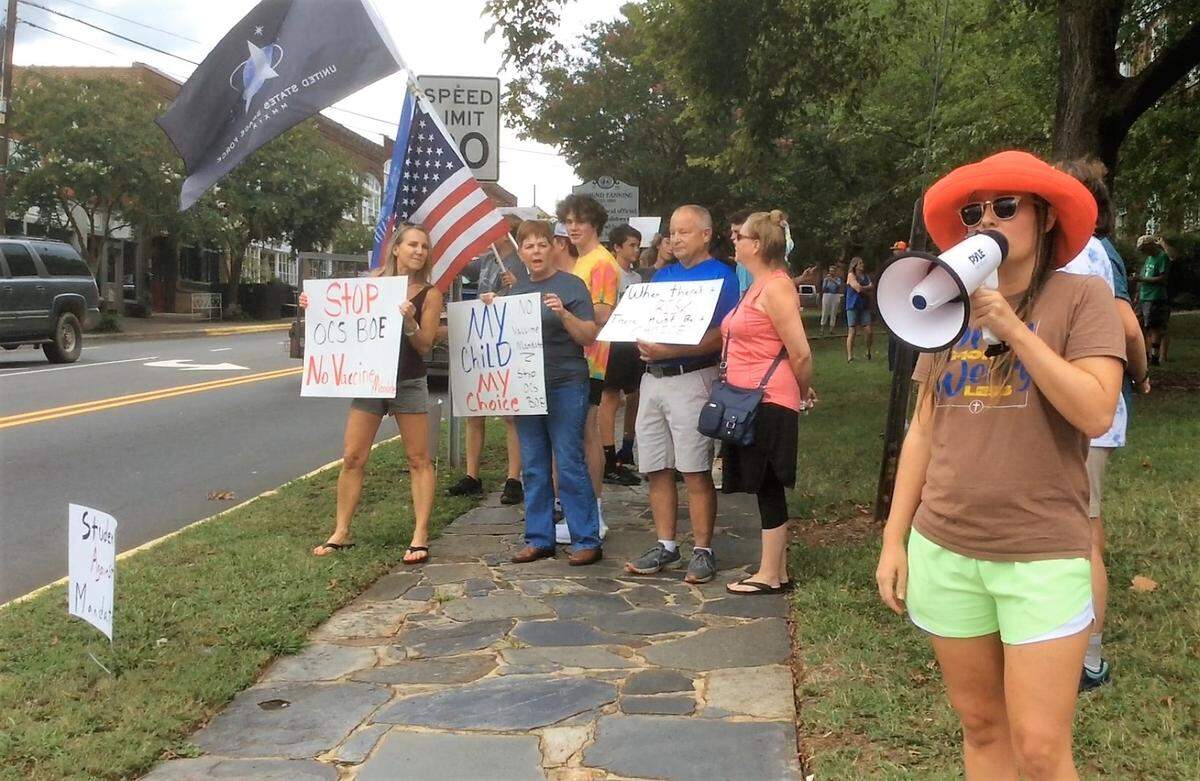 Over a hundred people gathered in downtown Hillsborough in 2021 to protest an Orange County Schools plan to require athletes and students participating in extracurricular activities to get vaccinated.