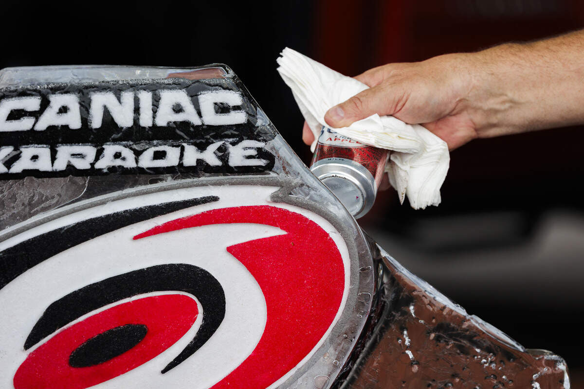 Paul Esterline chisels the edge of the CaneEvels Ice Luge with a Busch Light Apple beer can in the parking lot of the Lenovo Center on June 11, 2026, in Raleigh, North Carolina. The Carolina Hurricanes take on the Vegas Golden Knights for Game 5 of the Stanley Cup Final.