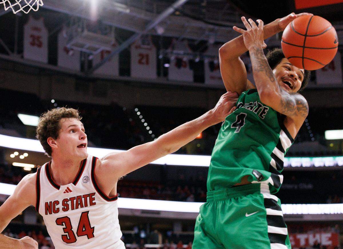 N.C. State’s Ben Middlebrooks and USC Upstate’s Carmelo Adkins scramble for a loose ball during the second half of the Wolfpack’s 97-66 win on Monday, Nov. 4, 2024, at the Lenovo Center in Raleigh, N.C.