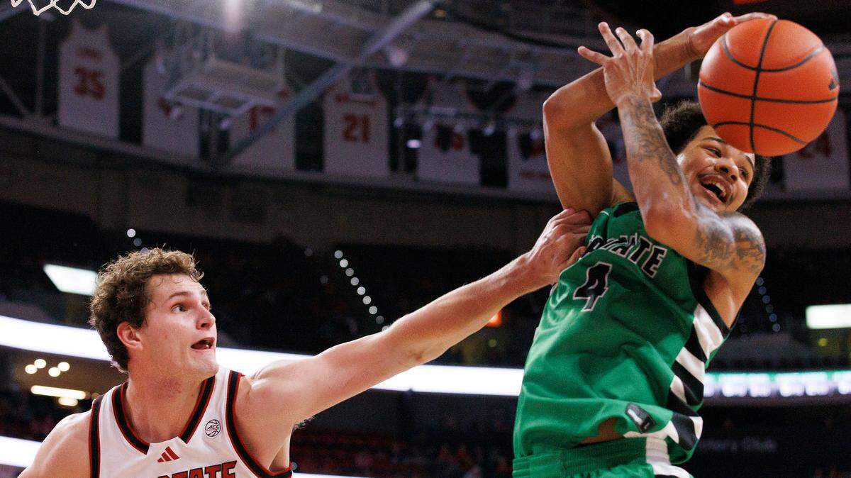N.C. State’s Ben Middlebrooks and USC Upstate’s Carmelo Adkins scramble for a loose ball during the second half of the Wolfpack’s 97-66 win on Monday, Nov. 4, 2024, at the Lenovo Center in Raleigh, N.C.