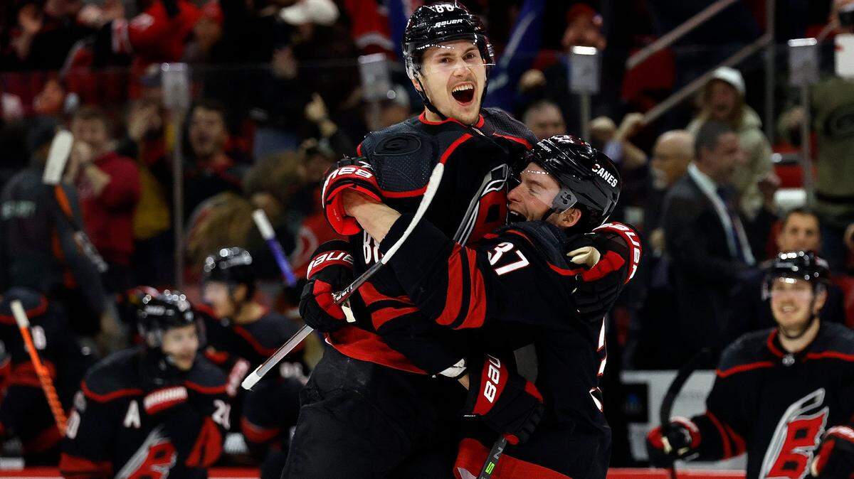 Carolina Hurricanes’ Martin Necas (88) celebrates his overtime goal against the San Jose Sharks with Andrei Svechnikov (37) in an NHL hockey game in Raleigh, N.C., Friday, Jan. 27, 2023. (AP Photo/Karl B DeBlaker)