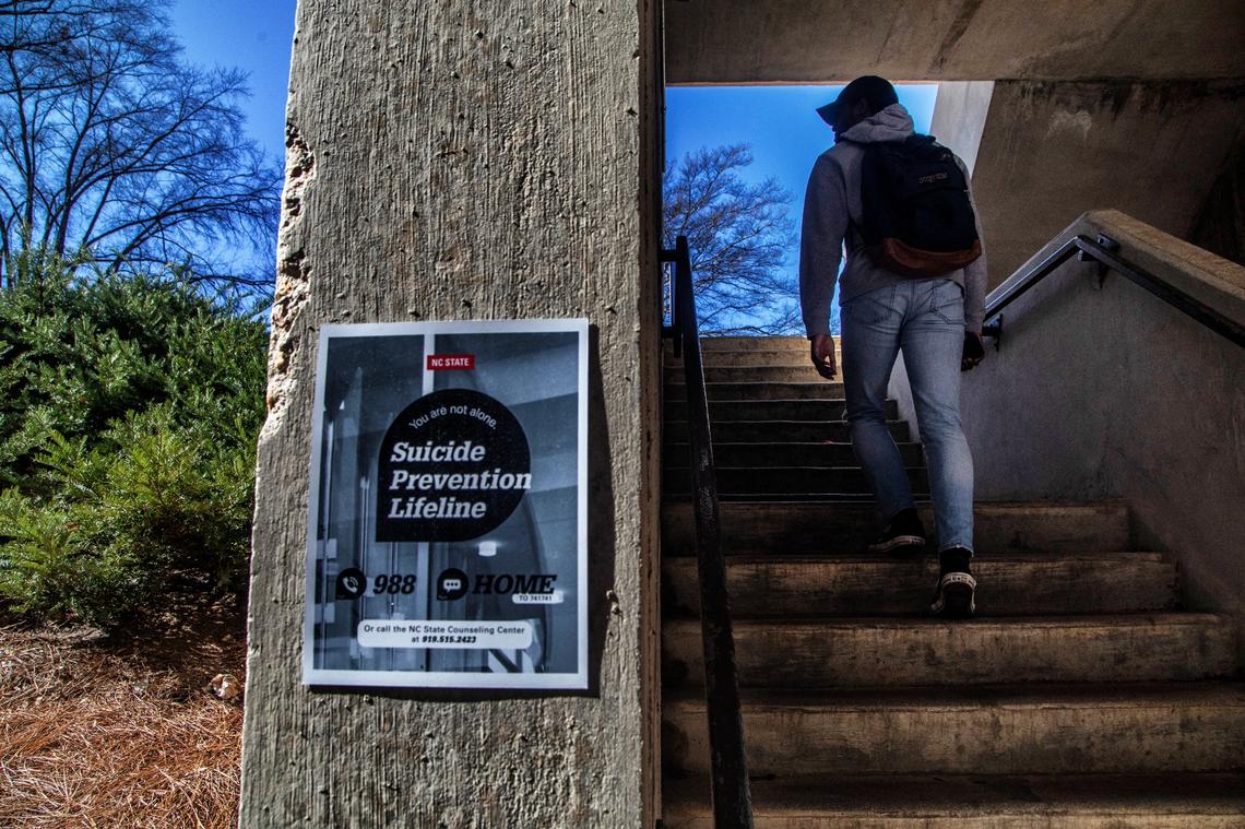 Signs, like this one in a parking deck stairwell on N.C. State’s main campus, advertise a suicide prevention help Monday, Feb. 13, 2022.