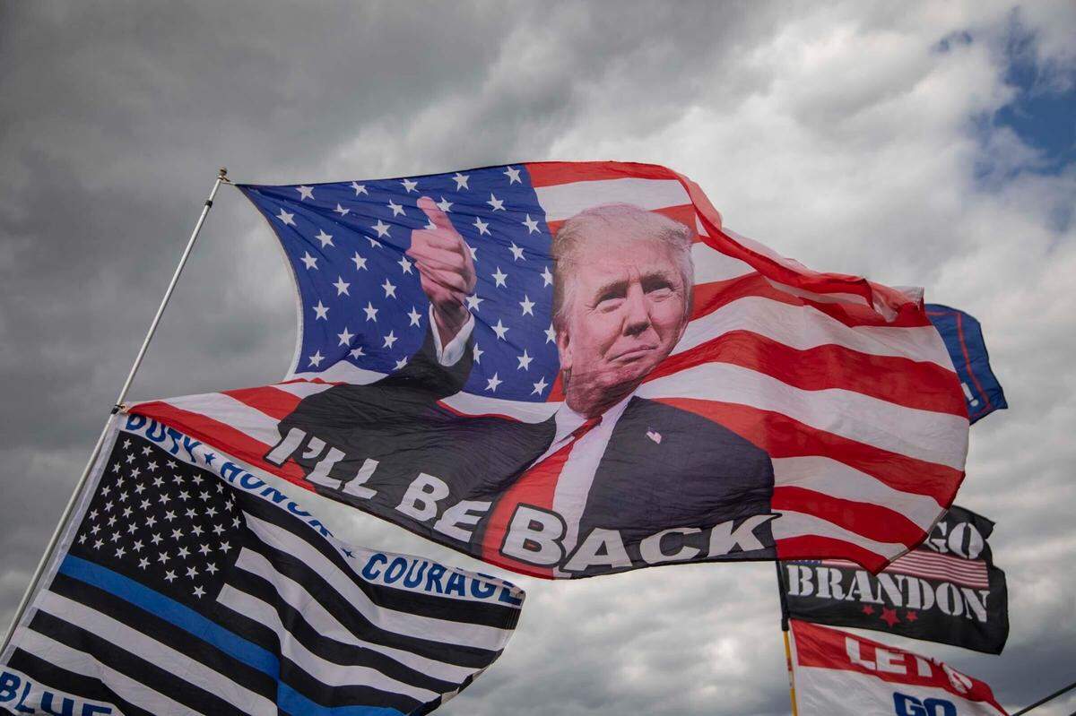 Flags at a Trump rally on April 9, 2022, in Selma, North Carolina.
