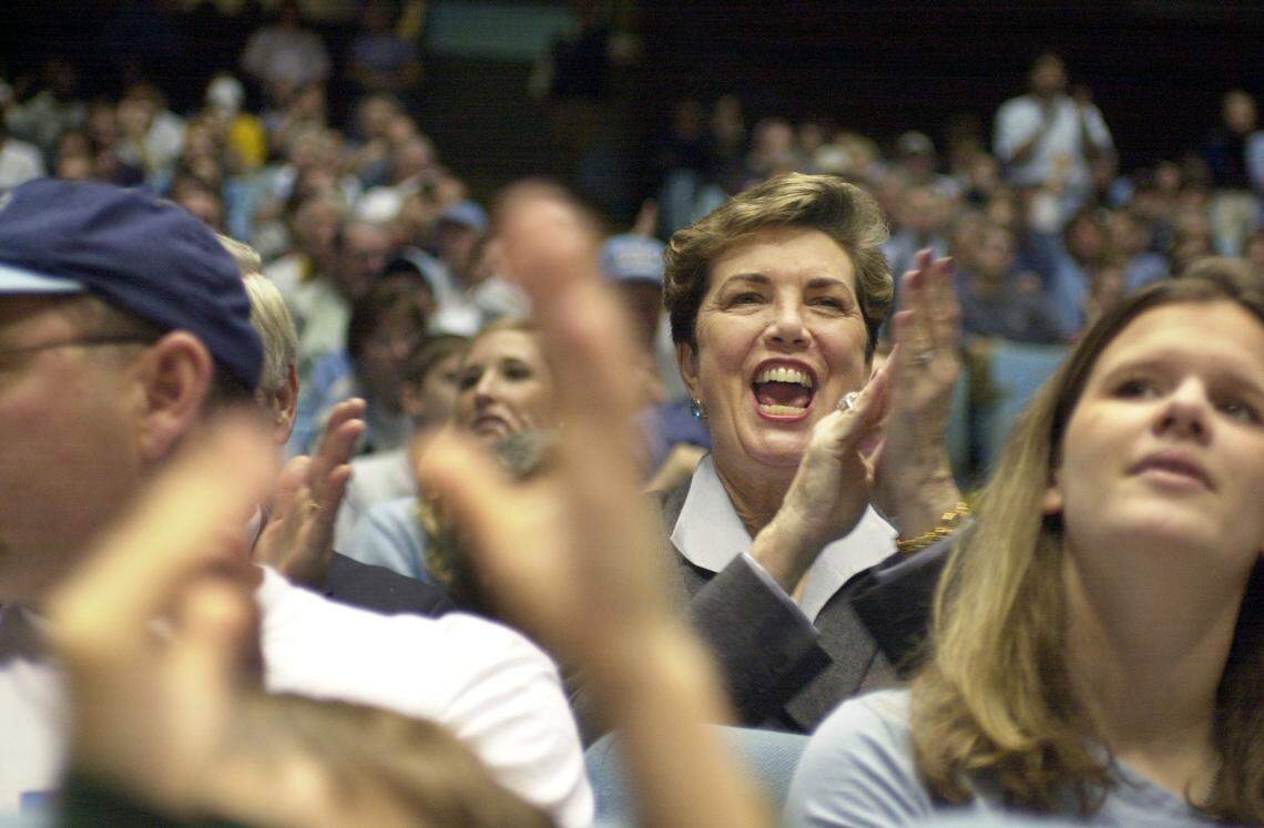 UNC system president Molly Broad cheers for the Tar Heels at a 2001 basketball game in the Dean Smith Center.