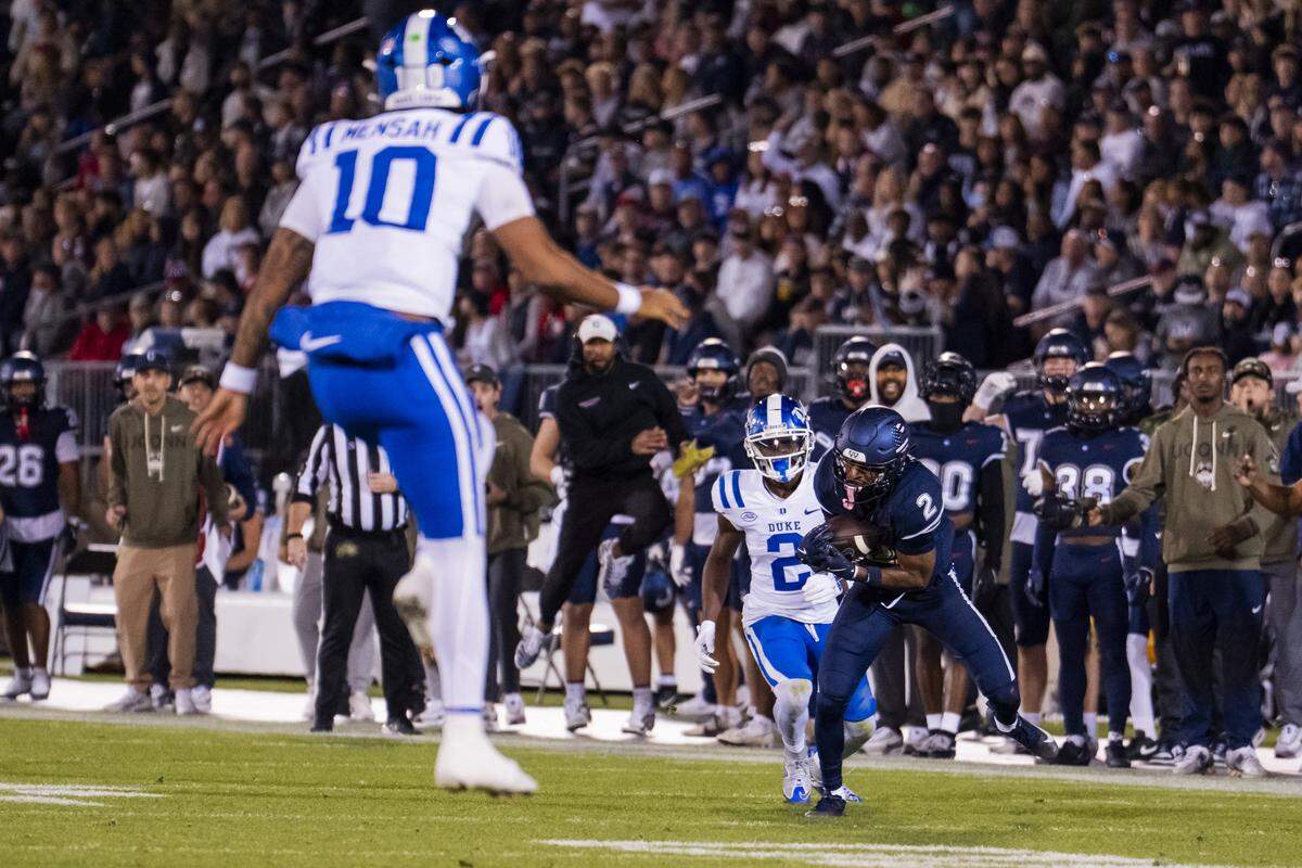 Devin Pringle (2) of the Connecticut Huskies intercepts Darian Mensah of the Duke Blue Devils during the first half of an NCAA football game at Rentschler Field on Nov. 8, 2025 in East Hartford, Connecticut.
