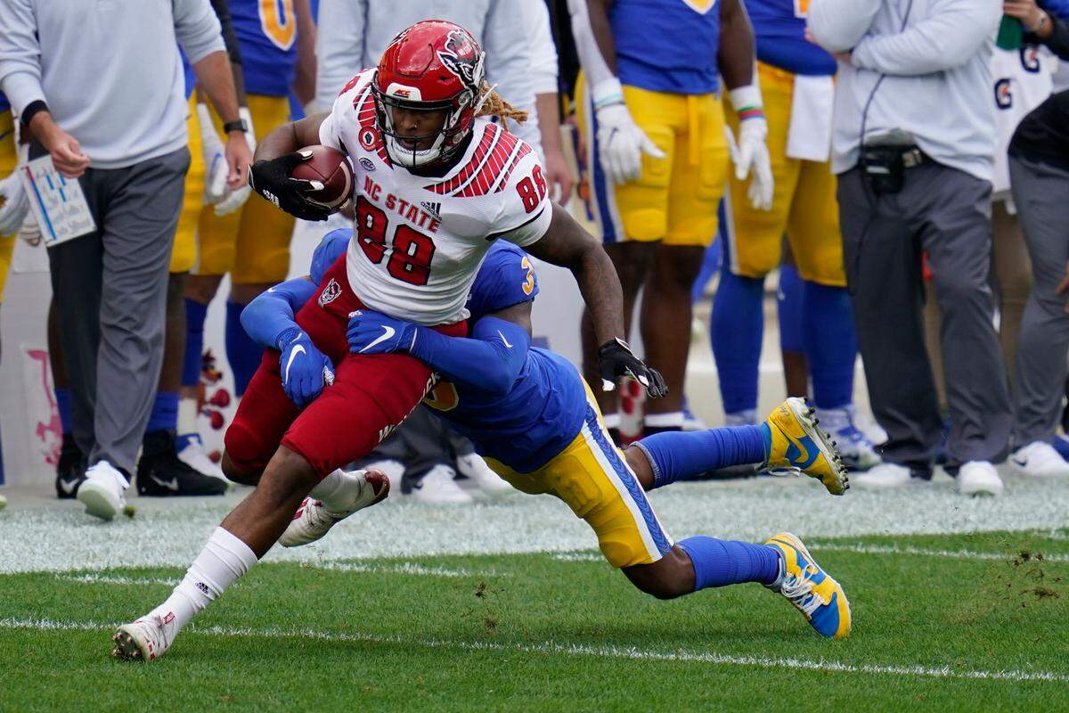 North Carolina State wide receiver Devin Carter (88) tries to break away from Pittsburgh Panthers defensive back Damar Hamlin (3) during the first half of an NCAA college football game, Saturday, Oct. 3, 2020, in Pittsburgh.