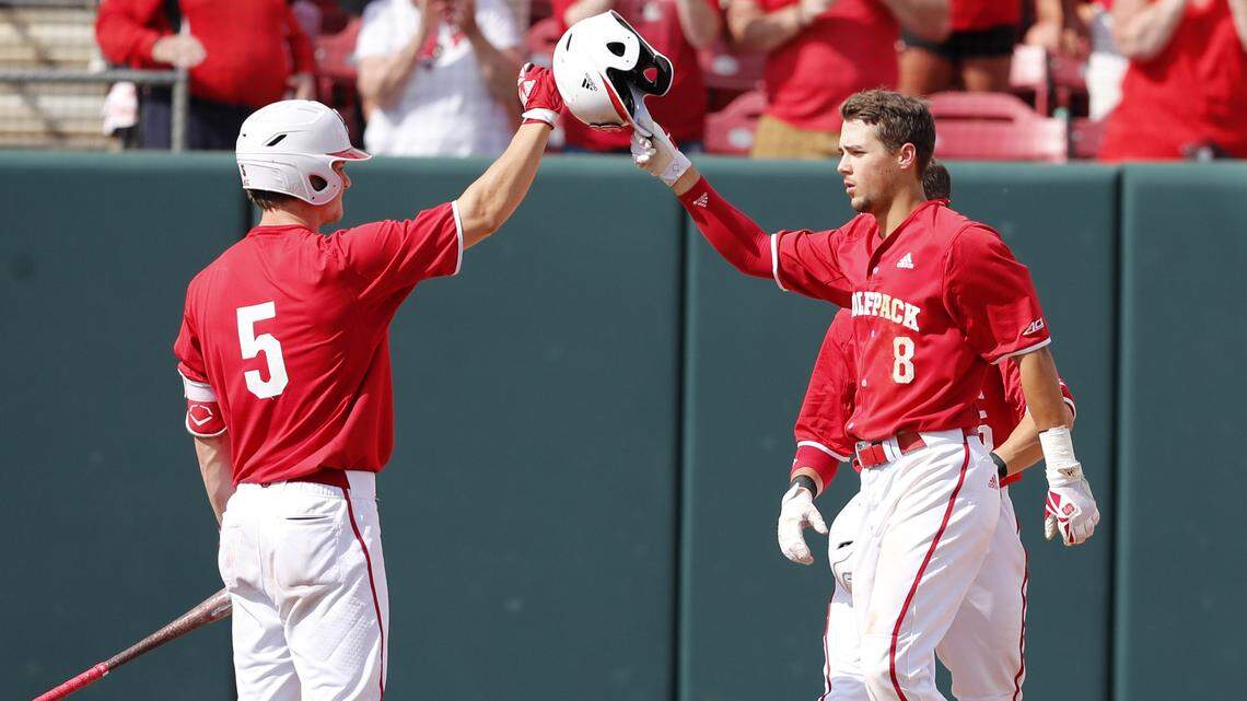 N.C. State's Will Wilson (8) celebrates with Patrick Bailey (5) after hitting a two-run home run during the Wolfpack's game against Army in the Raleigh Regional Sunday, June 3, 2018.