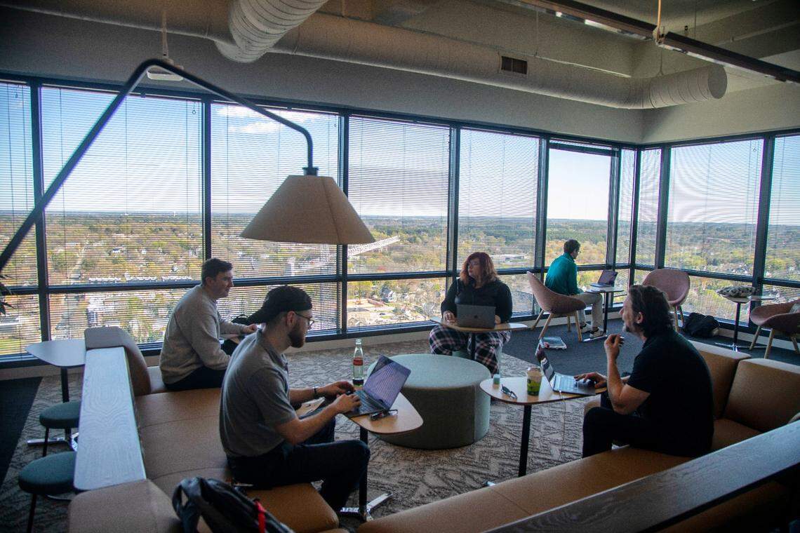 Red hat employees work in a communal office setting at Red Hat’s office building in Raleigh on Tuesday, March 7, 2023.