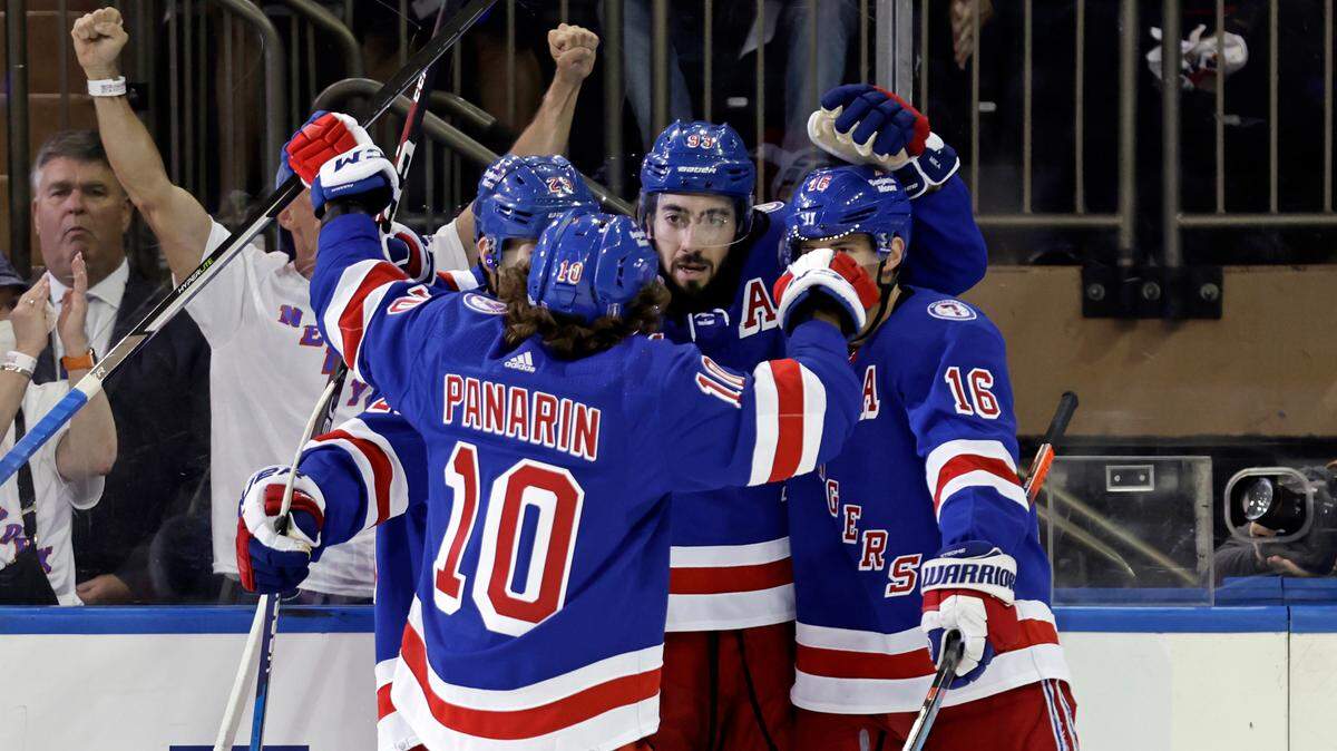 New York Rangers’ Mika Zibanejad is congratulated by teammates after scoring a power-play goal against the Carolina Hurricanes during the first period of Game 3 of an NHL hockey Stanley Cup second-round playoff series, Sunday, May 22, 2022, in New York. (AP Photo/Adam Hunger)