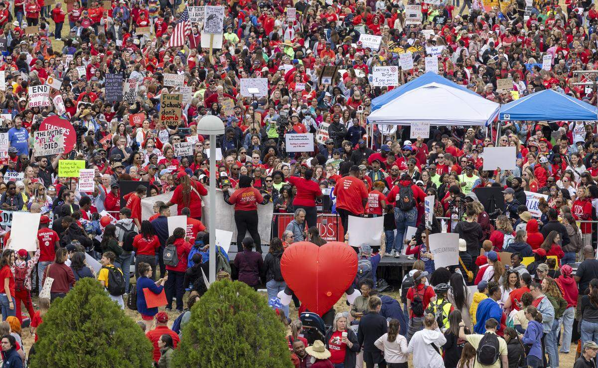 Demonstrators rally on the Halifax Mall for a May Day demonstration, before marching around the Capital, calling for higher teacher pay, and an end to corporate tax breaks and private school vouchers, on Friday, May 1, 2026 in Raleigh, NC.