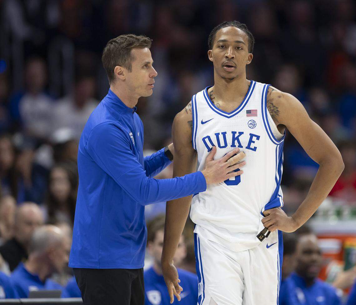Duke coach Jon Scheyer has a word with forward Maliq Brown (6) in the first half against Virginia on Saturday, March 14, 2026, during the ACC Tournament Championship at Spectrum Center in Charlotte, N.C.