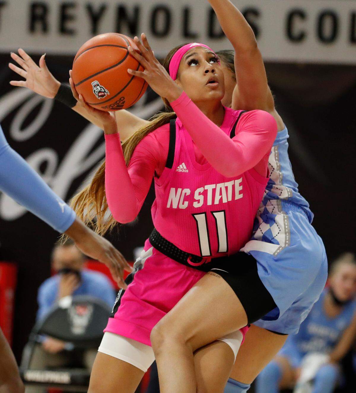 N.C. State’s Jakia Brown-Turner (11) shoots as North Carolina’s Stephanie Watts (5) defends during the first half of N.C. State’s game against UNC in the annual Play4Kay game at Reynolds Coliseum in Raleigh, N.C., Sunday, February 21, 2021.