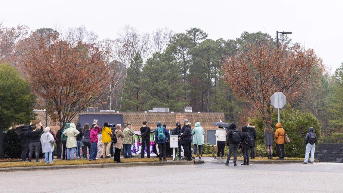 About 50 demonstrators rally outside a building rumored to be a U.S. Immigration and Customs Enforcement field office on Centrewest Court in Cary on Friday,, Nov. 21, 2025 to protest increased immigration enforcement in the Triangle.