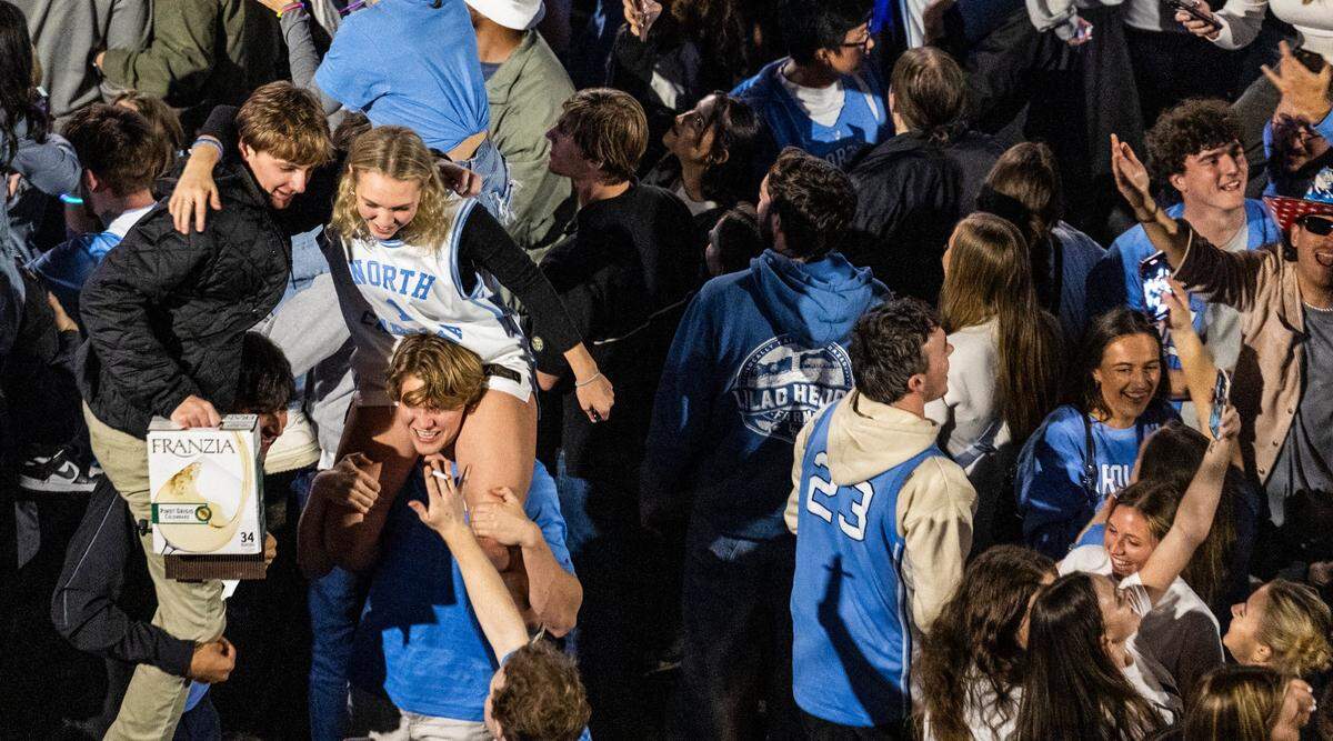 UNC-Chapel Hill basketball fans celebrate on Franklin Street following the UNC men’s basketball team’s 84-79 win over Duke at Cameron Indoor Stadium on Saturday, March, 9, 2024.